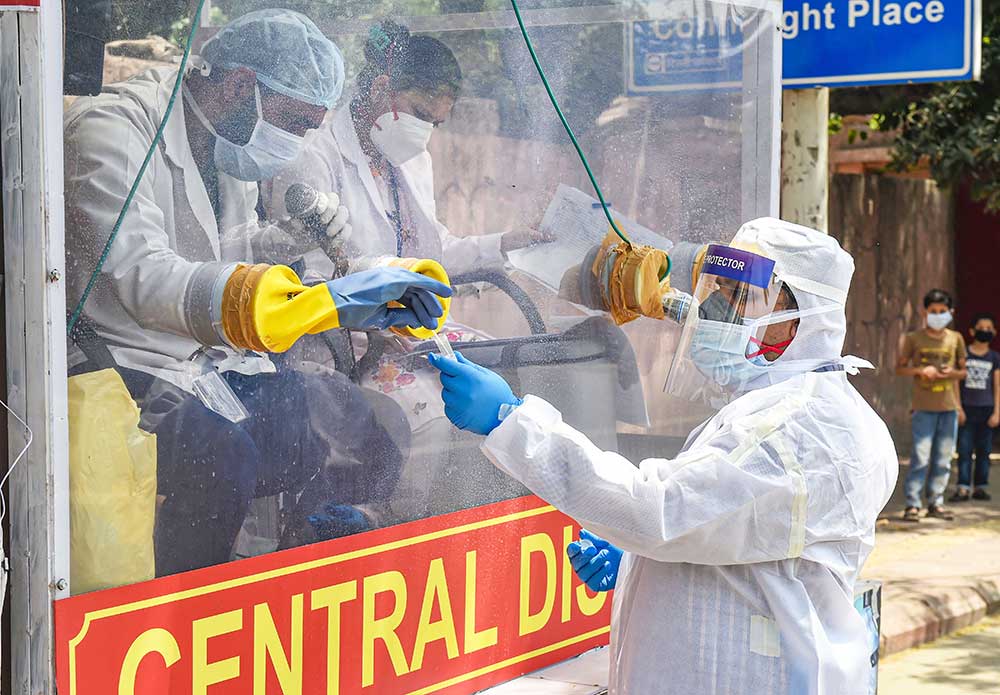 Medics prepare to collect samples for swab tests from a Covid-19 mobile testing van, during the nationwide lockdown to curb the spread of coronavirus, at Ramakrishna Mission area in New Delhi, Saturday, May 2, 2020.