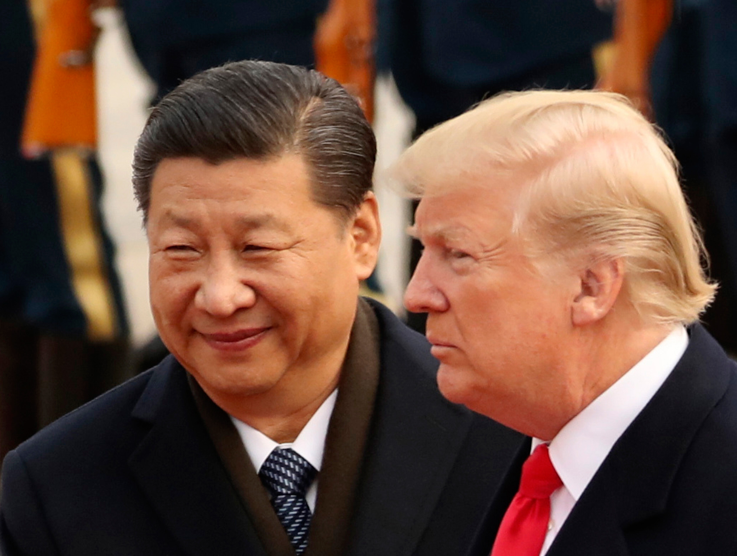 In this November 9, 2017, file picture, US President Donald Trump and Chinese President Xi Jinping participate in a welcome ceremony at the Great Hall of the People in Beijing, China