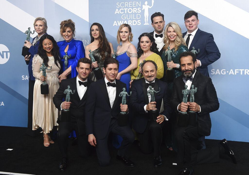 Jane Lynch, from top left, Stephanie Hsu, Carolina Aaron, Marin Hinkle, Rachel Brosnahan, Alex Borstein, Luke Kirby, Matilda Szydagis, and Sean Tarantina. Joel Johnstone, from bottom left, Michael Zegen, Kevin Pollak, and Tony Shalhoub pose in the press room with the award for outstanding performance by an ensemble in a comedy series for "The Marvelous Mrs. Maisel" at the 26th annual Screen Actors Guild Awards at the Shrine Auditorium & Expo Hall on Sunday, January 19, 2020, in Los Angeles.