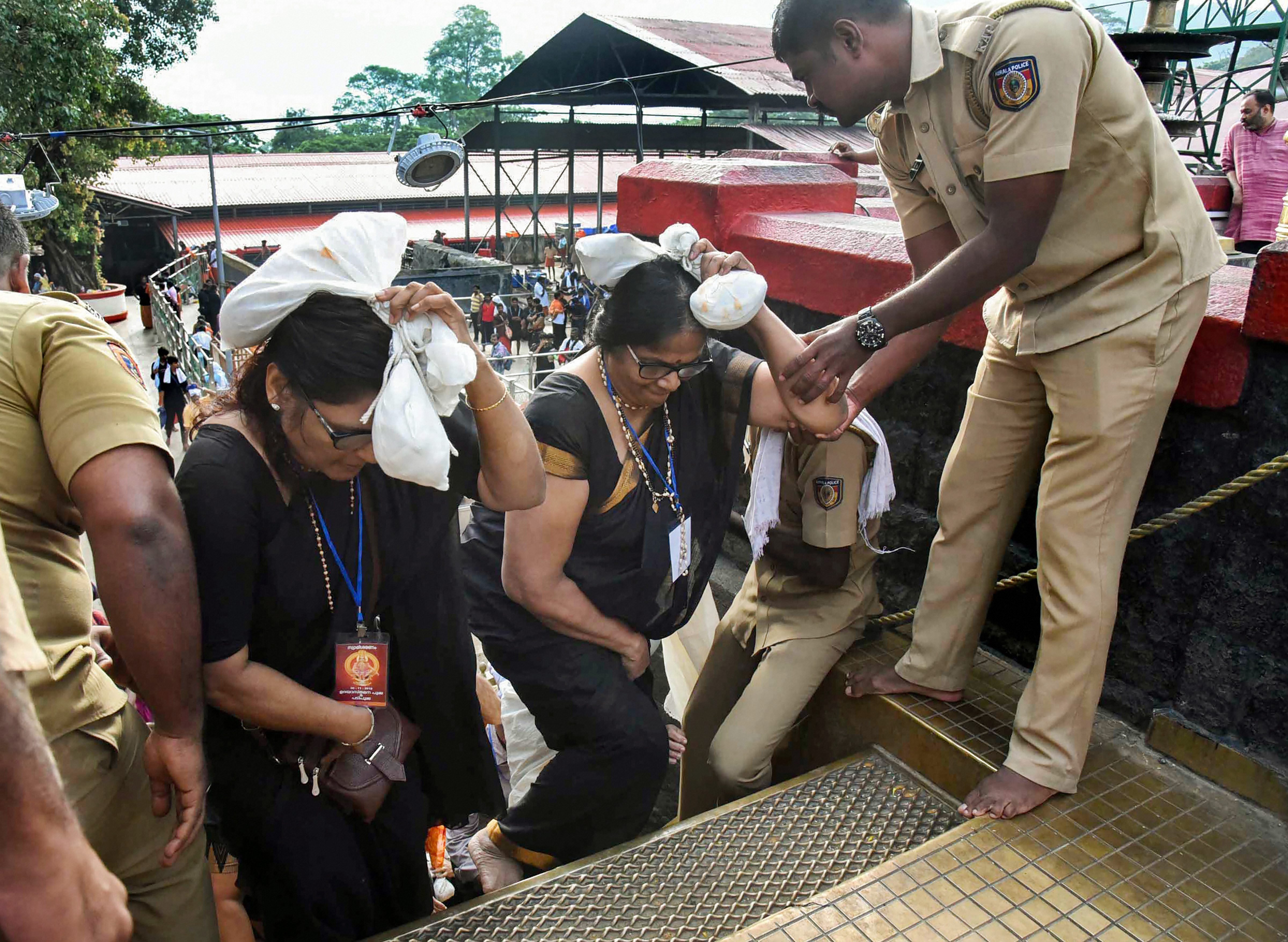 Police escort women into the Sabarimala temple on Tuesday.