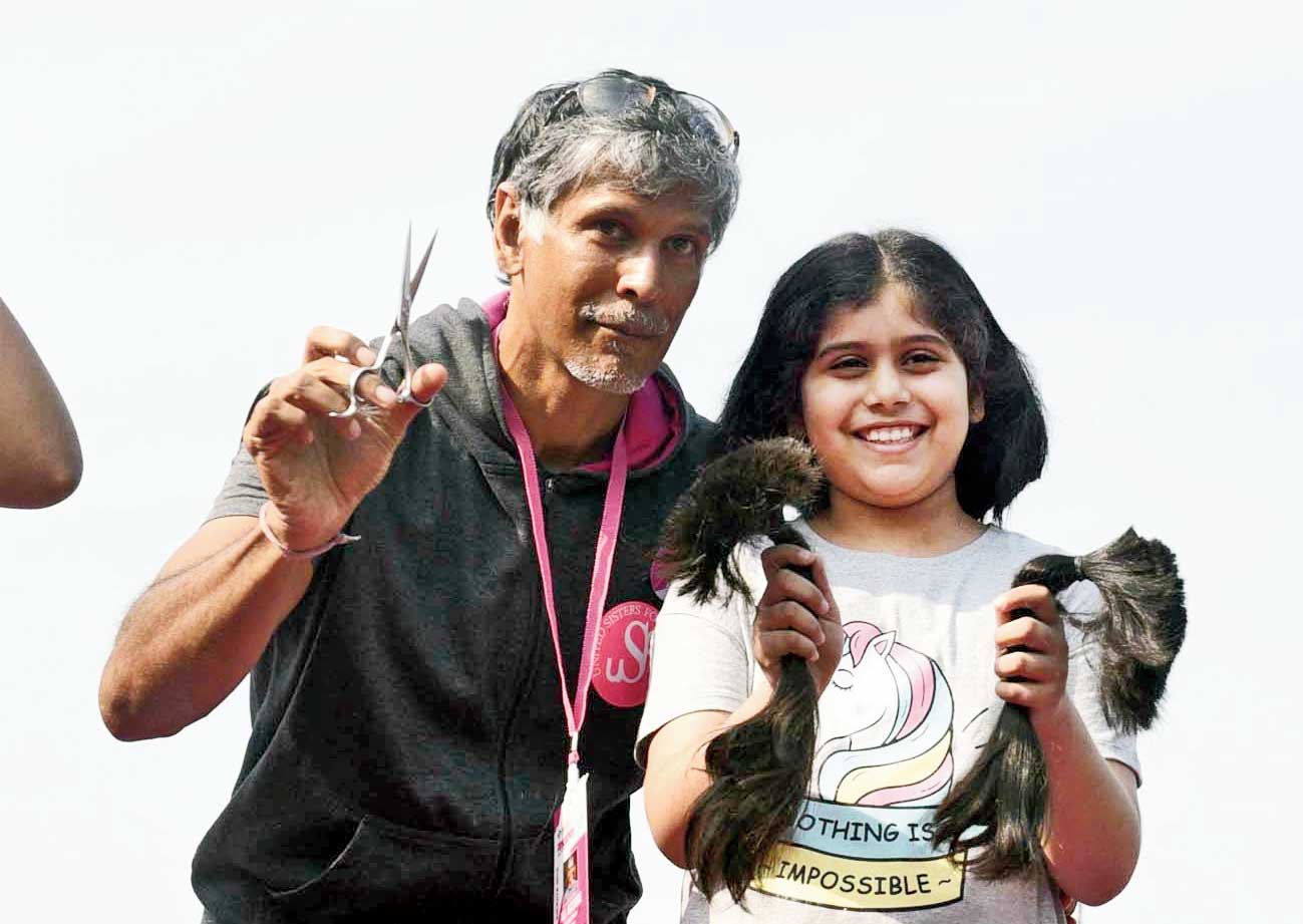 Kaavya Jain with Milind Soman after donating her hair for wigs for children suffering from cancer