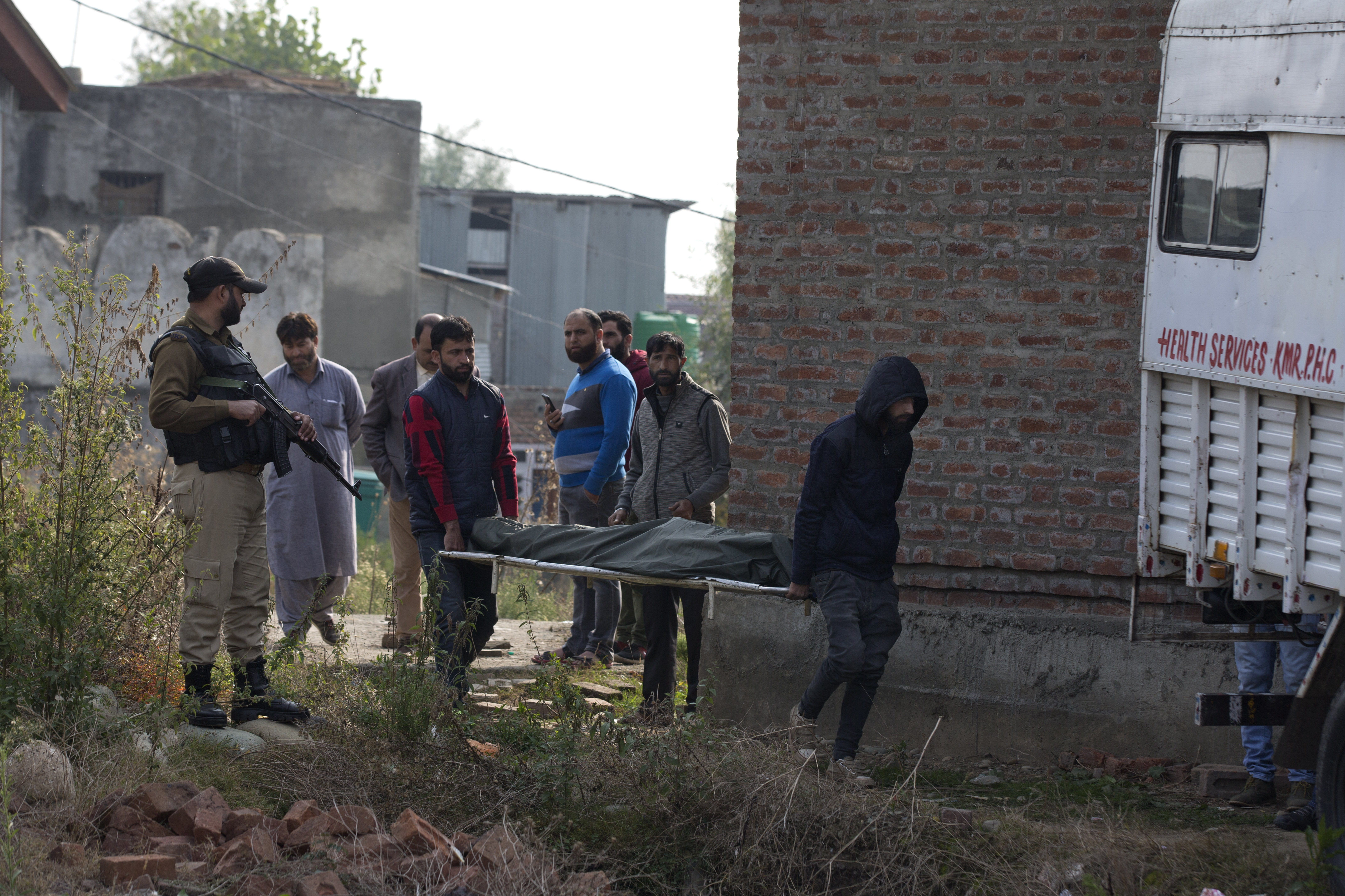 Kashmiri villagers carry the body of a migrant worker who was shot dead by gunmen towards a waiting ambulance outside a hospital in Kulgam, on October 30, 2019