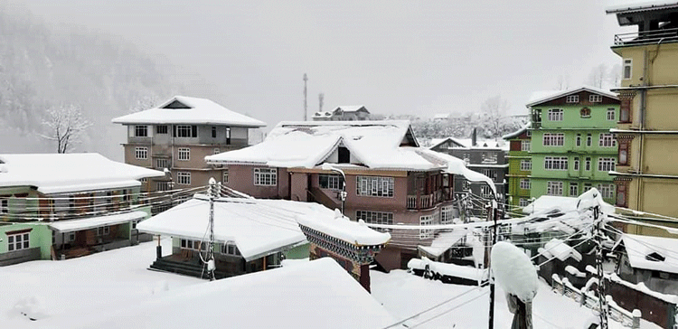 Rooftops enveloped in snow at Lachen in North Sikkim on Saturday