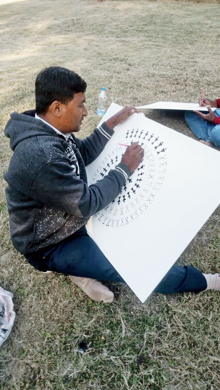 Sanjay Sutar from Maharashtra works on Warli painting at the national tribal and folk art workshop at Netarhat in Latehar district on Tuesday