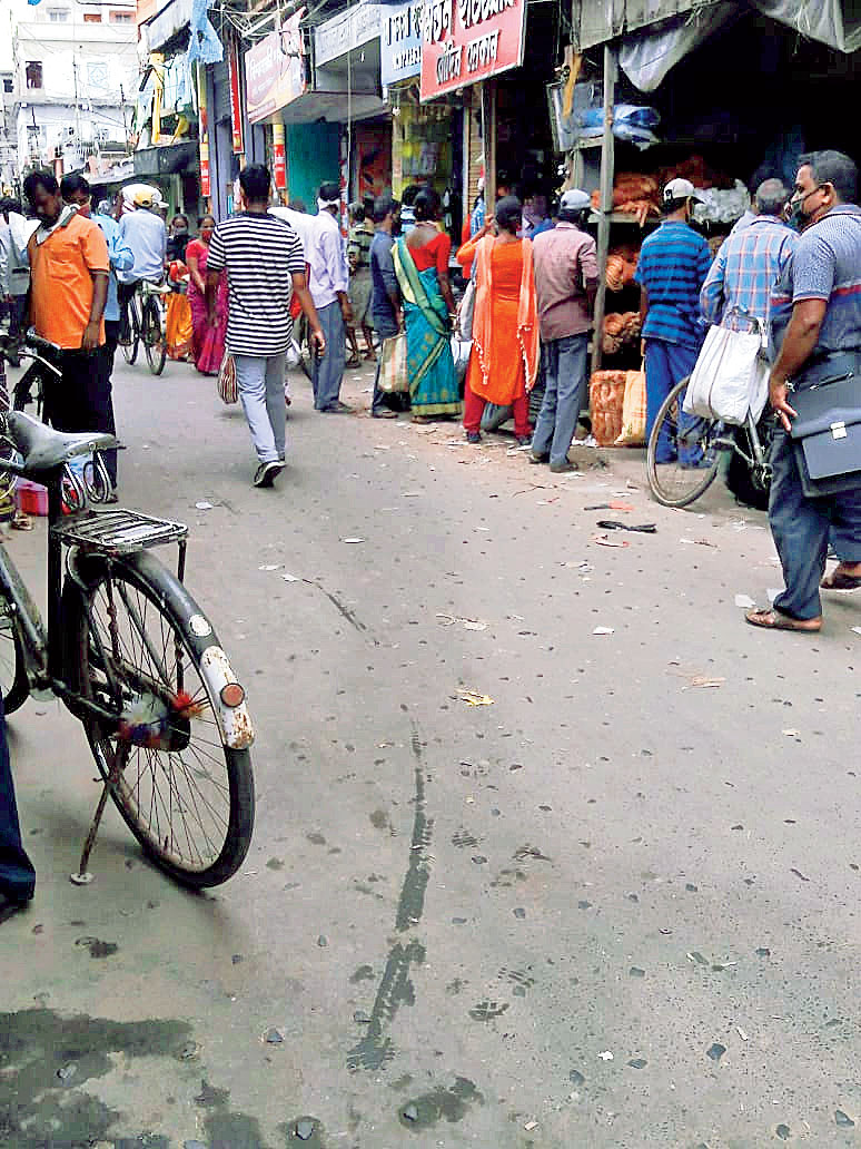 A queue in front of a hardware shop to buy asbestos sheets at Kakdwip