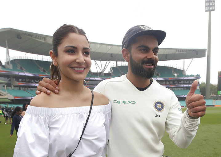 Virat Kohli celebrates with wife Anushka Sharma after winning the Test series against Australia in Sydney on Monday.