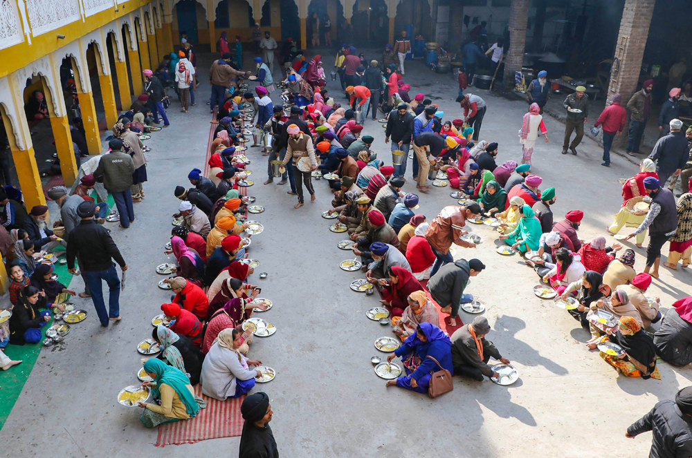 Devotees at a langar in a gurdwara on the occasion of the birth anniversary of Guru Gobind Singh in Jammu on January 2