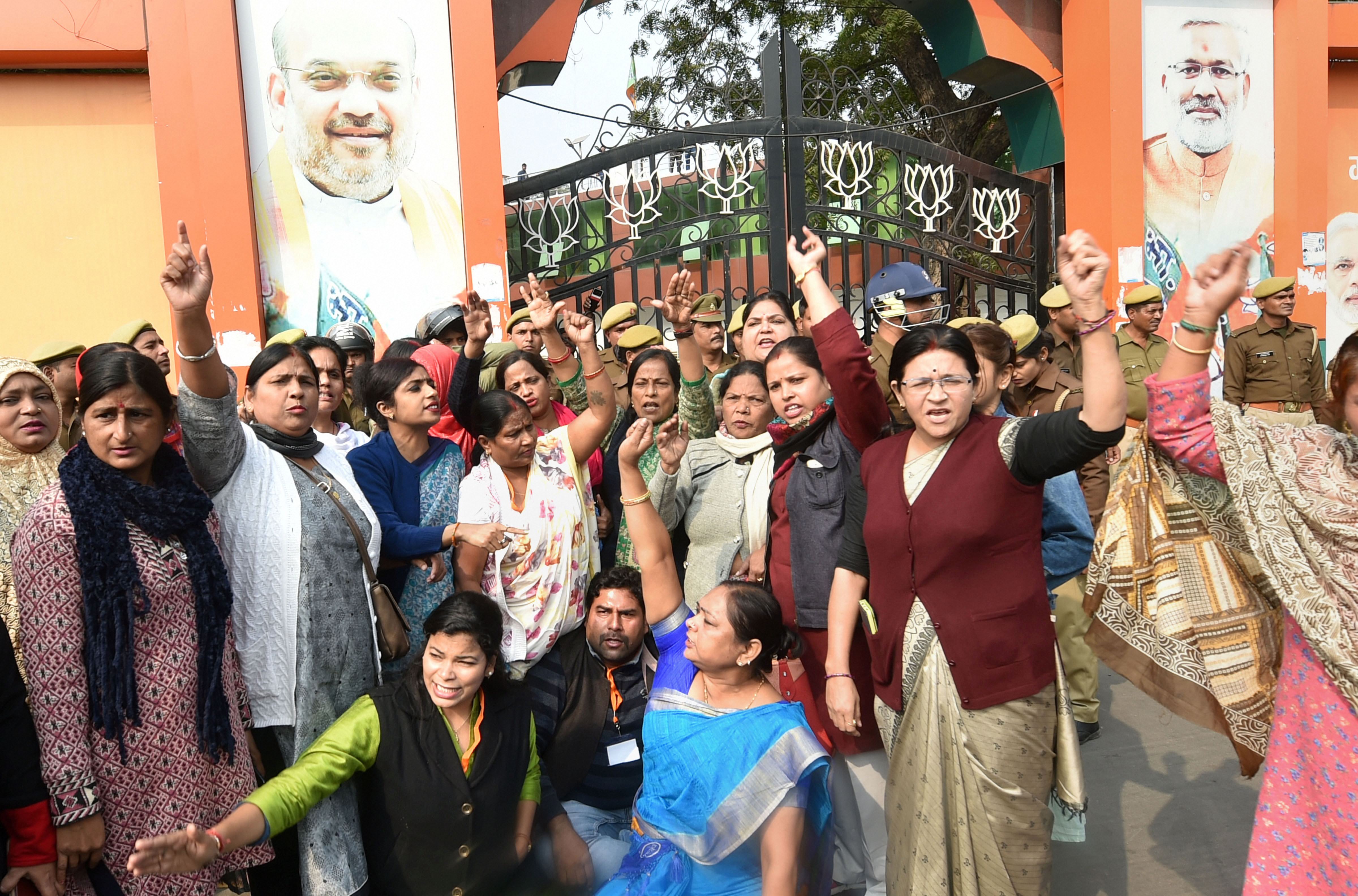 Congress workers stage a protest in front of UP BJP headquarters over Unnao rape victim's death, in Lucknow, Saturday, December 7, 2019