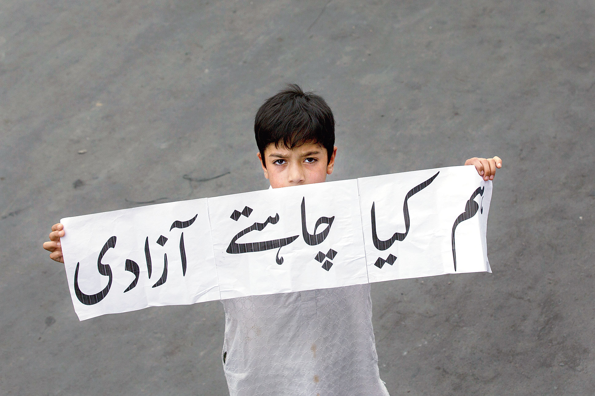 A Srinagar boy holds a banner that reads 'we want freedom'. The commission has also recommended to the US government targeted sanctions on Indian government agencies and officials responsible for severe violations of religious freedom by freezing their assets and/or barring their entry into the US.