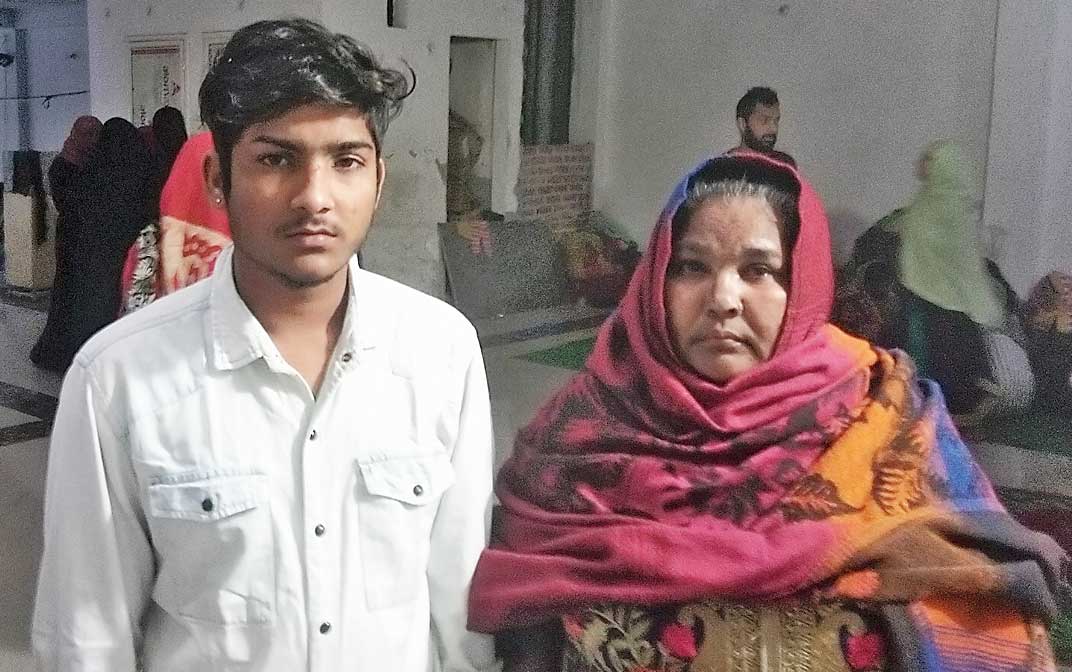 Class VIII student Firoze Khan with mother Shamma Parveen at a temporary camp in Mustafabad, northeast Delhi.