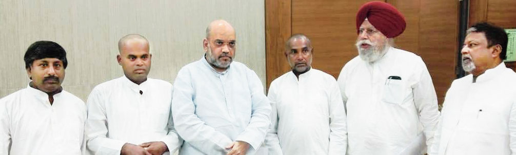 Relatives of the Daribhit clash victims with BJP chief Amit Shah in Delhi on Sunday
