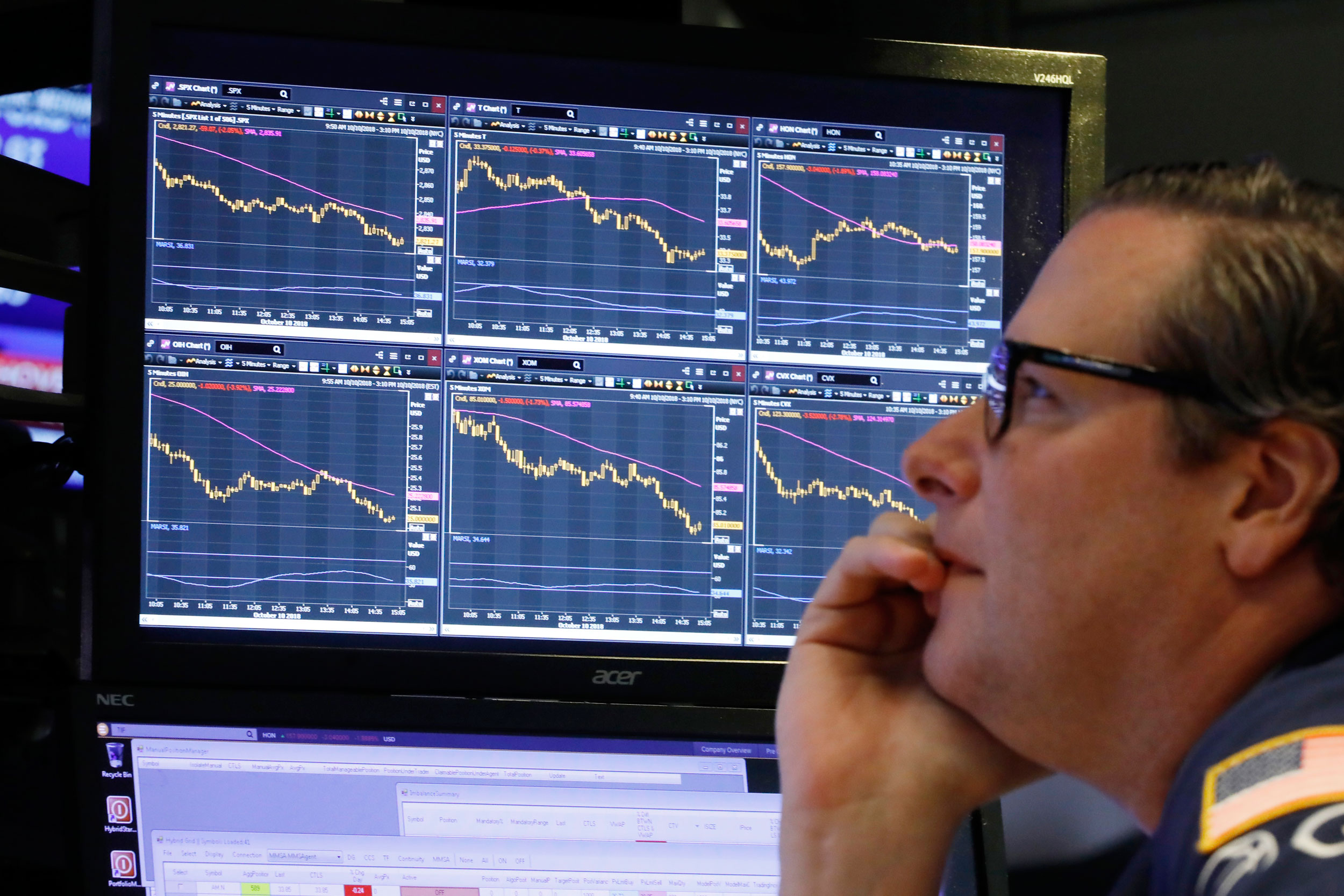 Specialist Gregg Maloney works at his post on the floor of the New York Stock Exchange. 