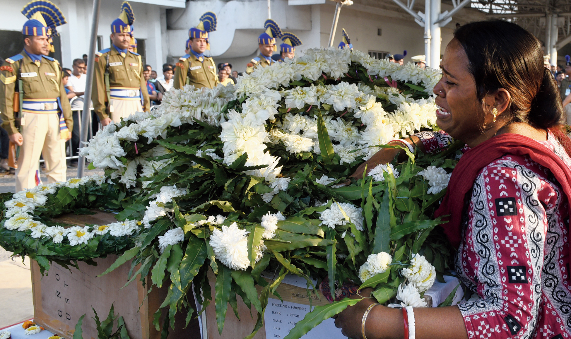 Tinku Das, a cousin of CRPF constable Sudip Biswas, breaks down as his coffin and that of head constable Bablu Santra arrives at the Calcutta airport on Saturday.