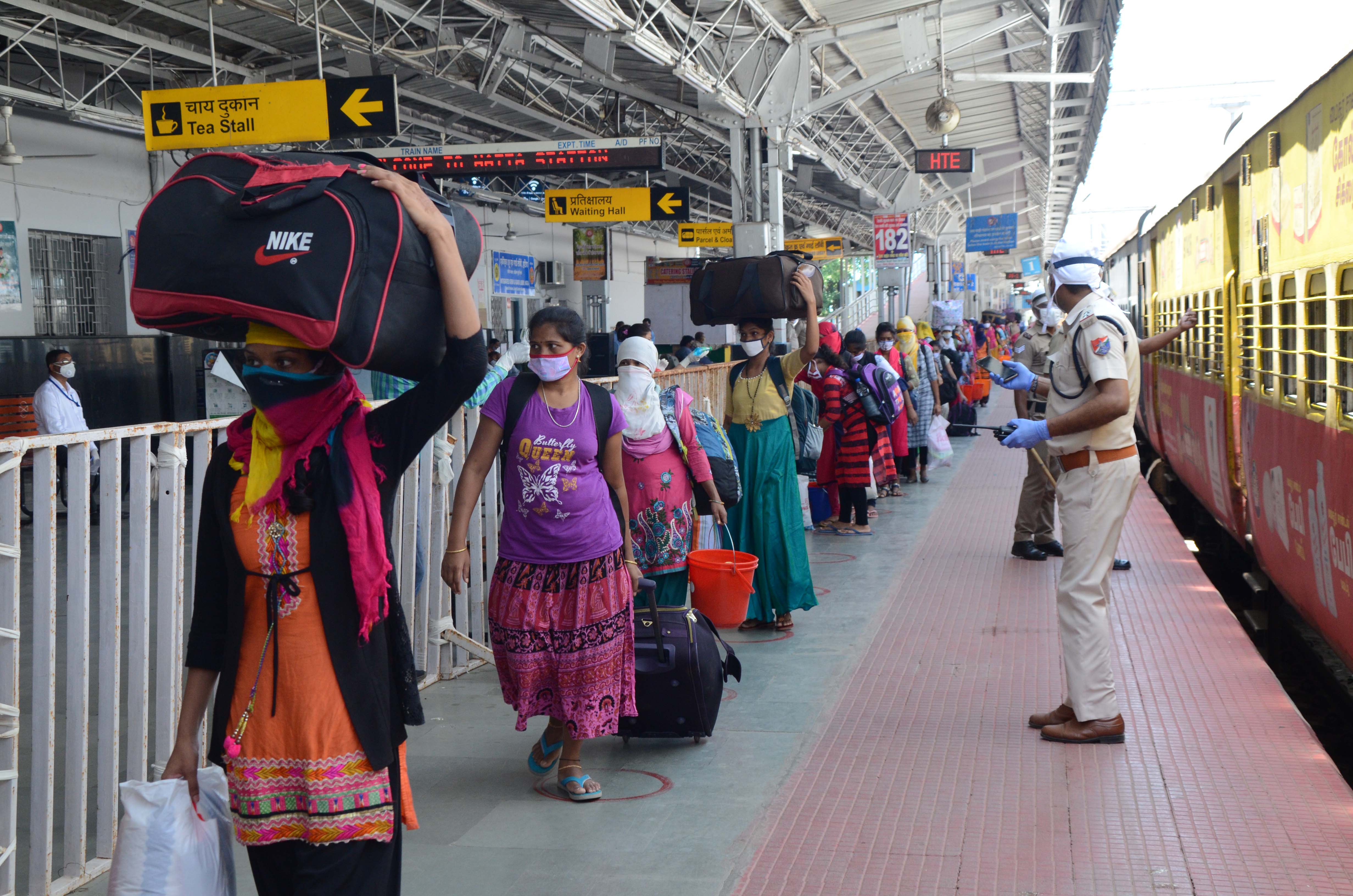 Migrant workers and their families leave the platform after their train reached Ranchi station on Saturday. 