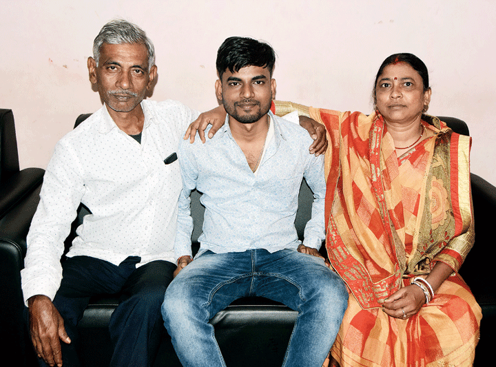 Ajay Kumar Sahu with his parents at their residence in Kumharpatti in Manaitand, Dhanbad, on Tuesday
