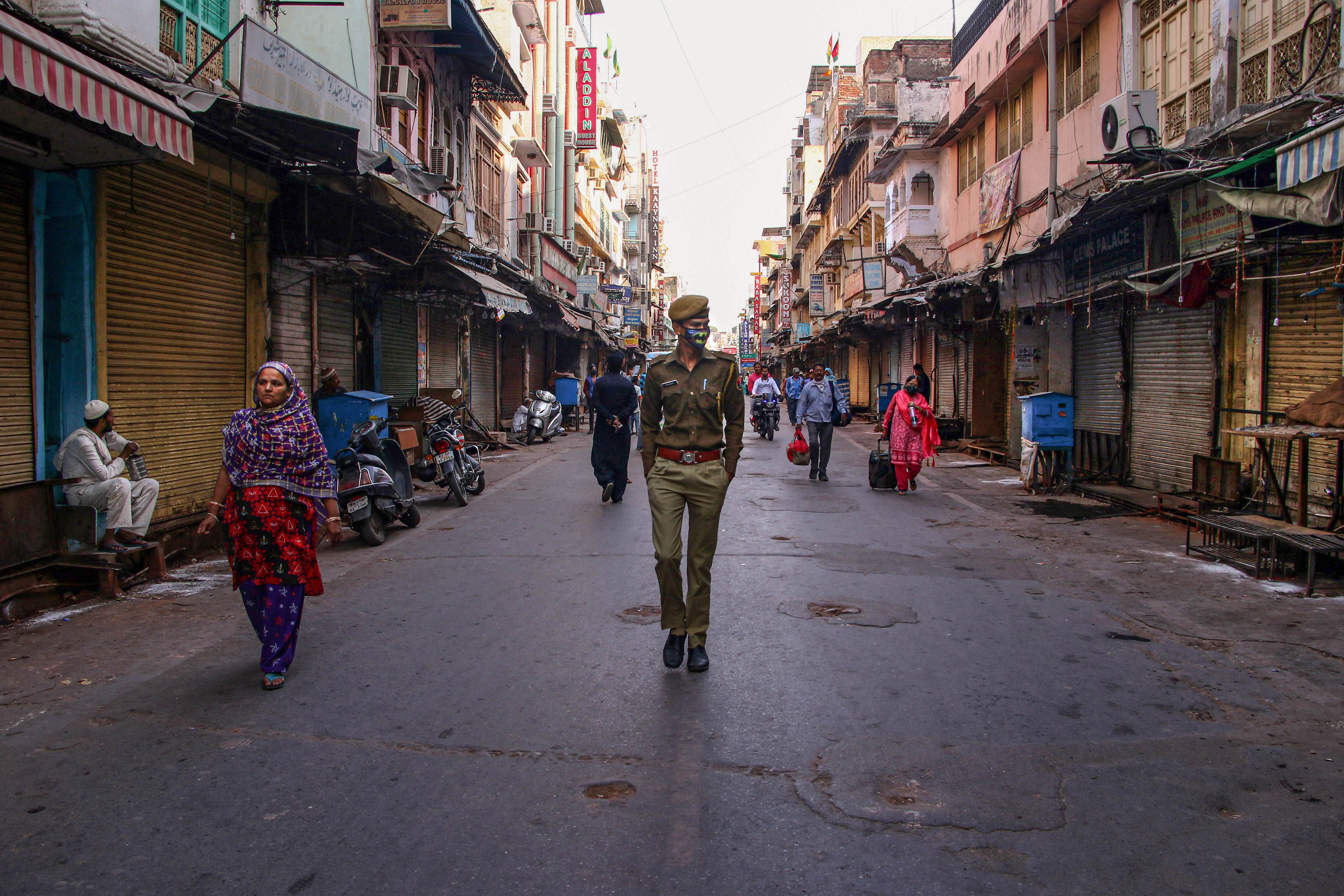 Sparse crowd is seen outside the shrine of Sufi saint Khwaja Moinuddin Chishti after it was closed for visitors in wake of the deadly novel coronavirus, in Ajmer, Saturday, March 21, 2020.