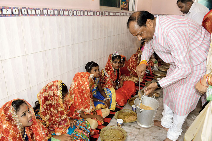 CM Raghubar Das serves halwa to girls at Shitala Mandir in Bhalubasa, Jamshedpur, on Monday.