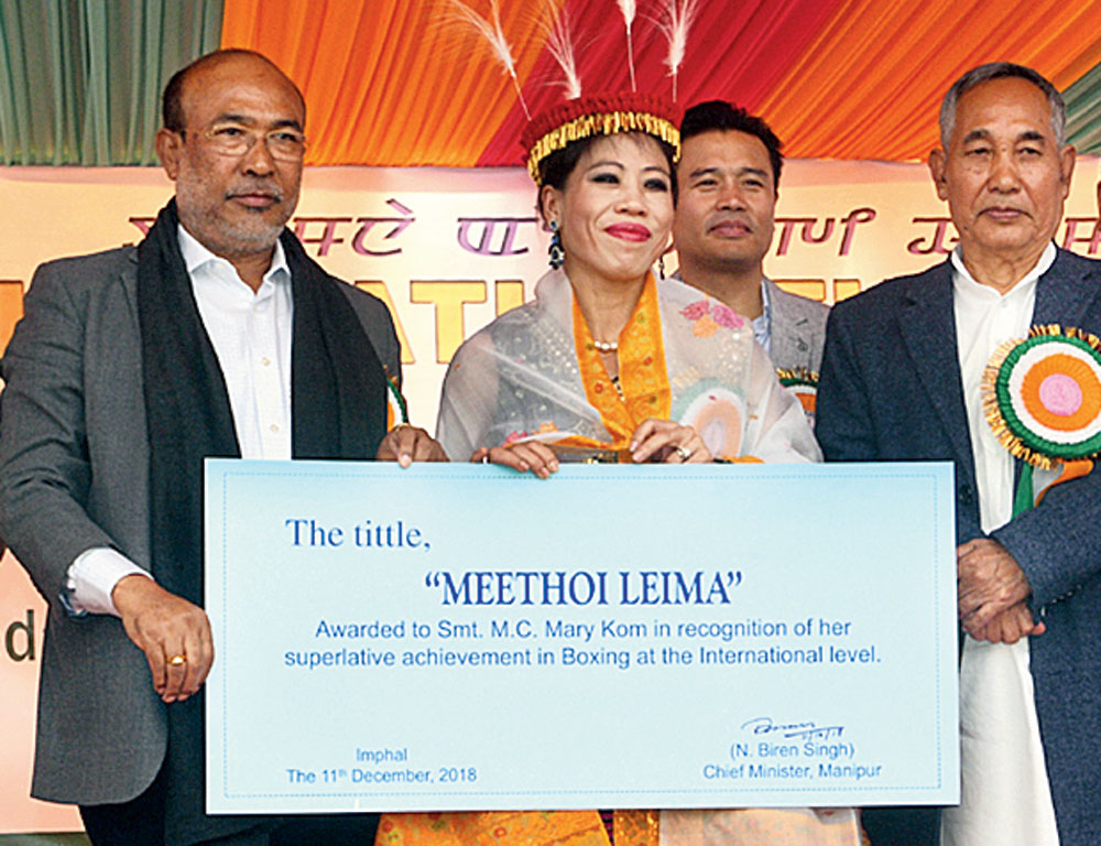 N. Biren Singh confers the Meethoi Leima title on M.C. Mary Kom in Imphal on Tuesday. 
