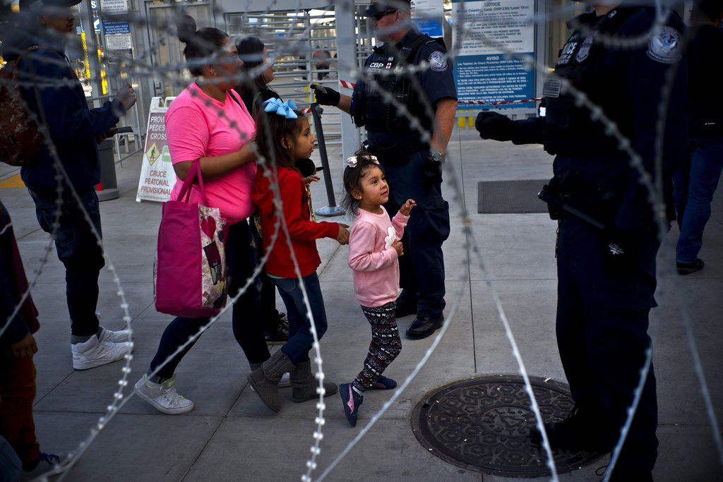 American officials check the identifications of people entering the US from Tijuana, Mexico, on Monday.