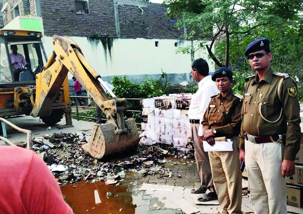 Liquor bottles being destroyed at Nadi Than in Patna’s  Fatuha on Tuesday. 
