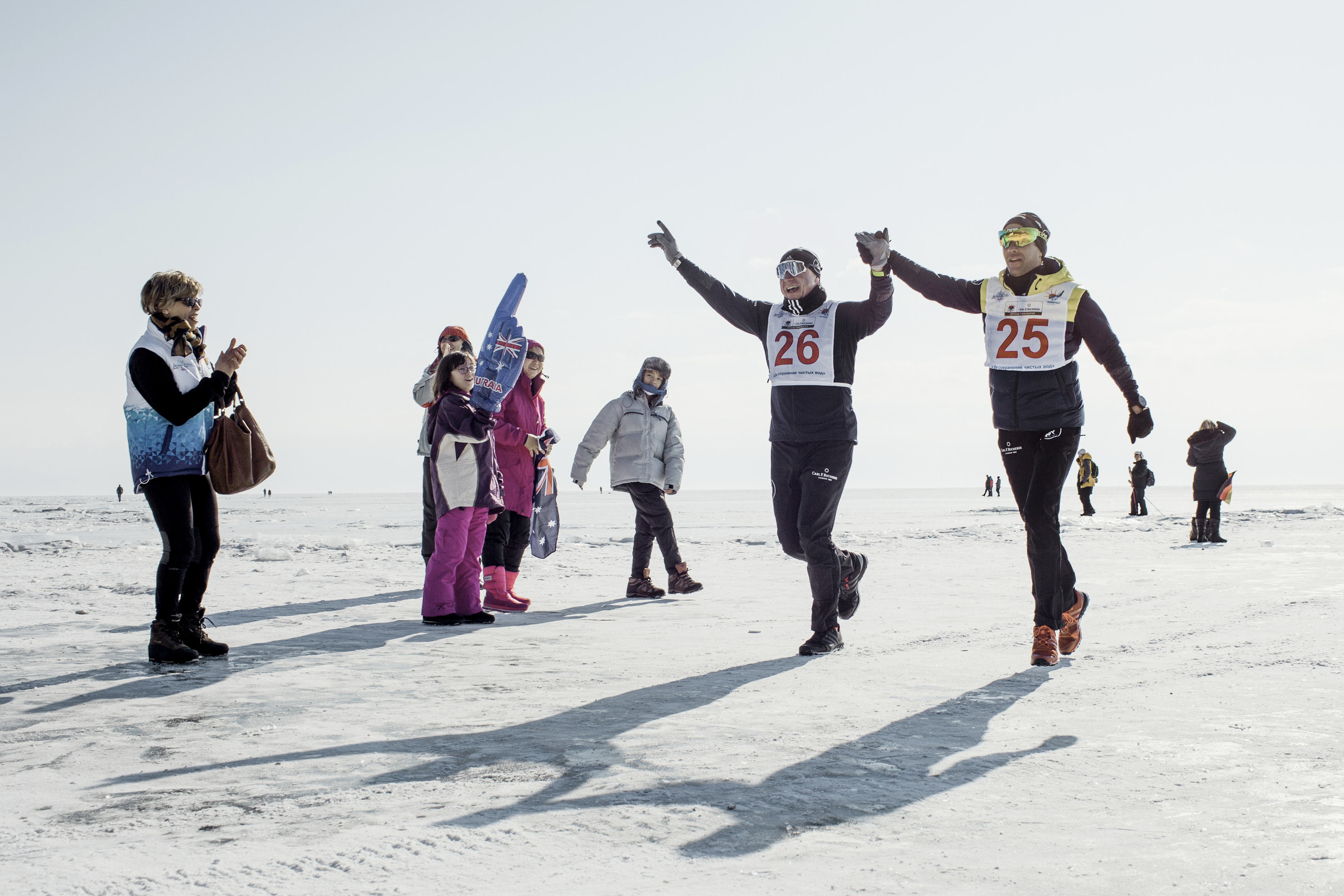 Running partners Vladimir Voloshin (left) and Laurent Lecamp at the finish line of the Baikal ice marathon.