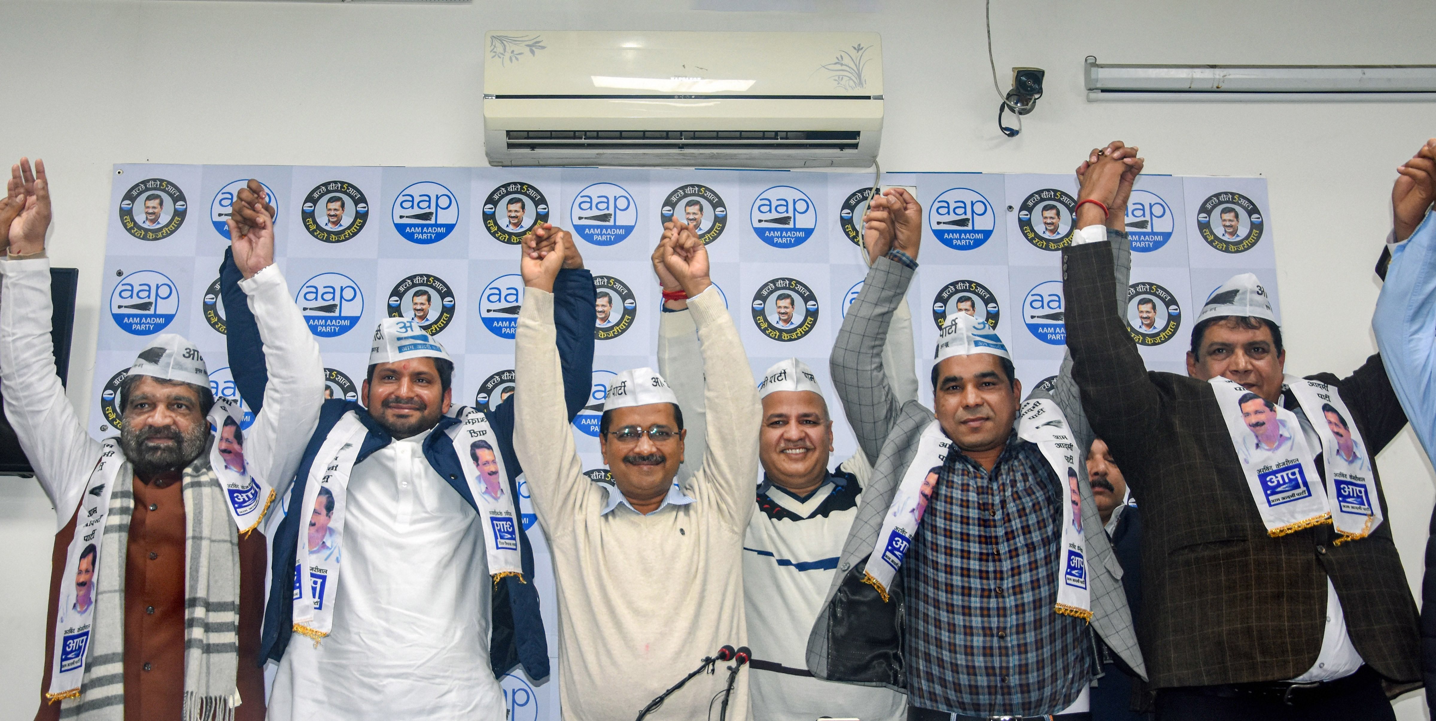 Vinay Mishra (2L), son of former Congress leader Mahabal Mishra, and former Badarpur MLA Ram Singh Netaji (L) join hands with Delhi CM Arvind Kejriwal, deputy CM Manish Sisodia and others after formally joining the AAP, in New Delhi, Monday, January 13, 2020.