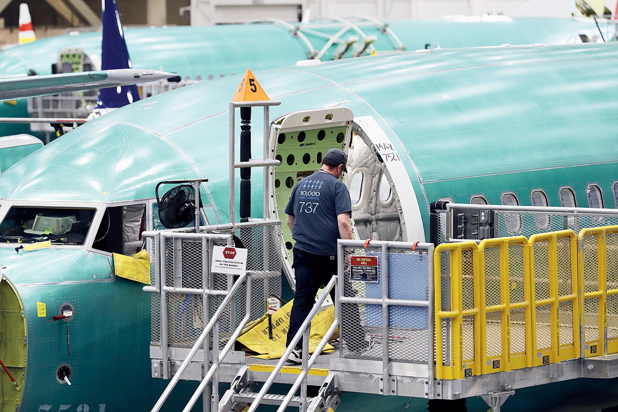 A worker enters the fuselage of a Boeing 737 Max 8 plane at their assembly facility in Renton, Washington.