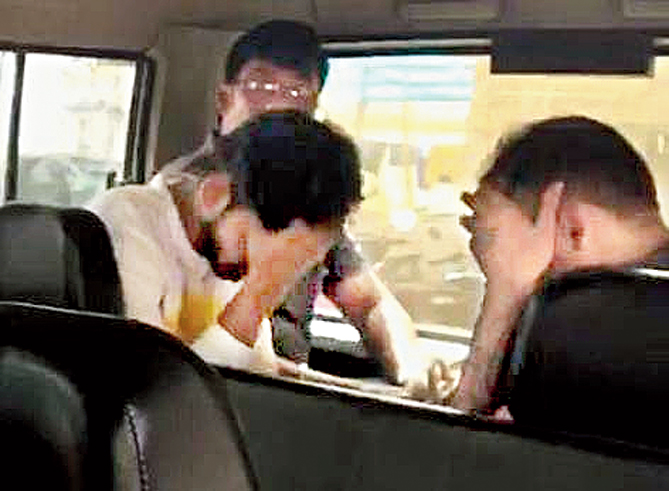 Two of the suspects in a police jeep