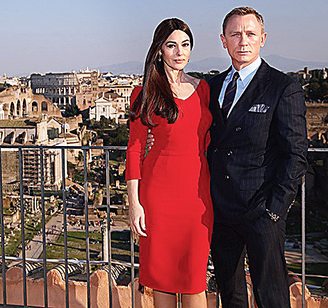 Daniel Craig sported a a double-breasted pinstripe suit by Brunello Cucinelli while promoting Spectre with Monica Bellucci.