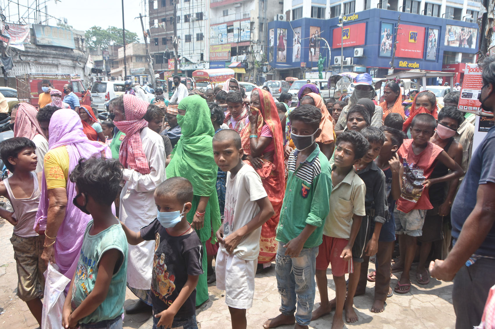 People violate social-distancing norms during the distribution of slippers in Dhanbad on Monday