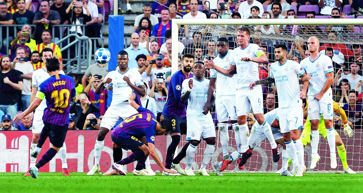 Barcelona’s Lionel Messi scores from a free-kick against PSV Eindhoven at Nou Camp on Tuesday