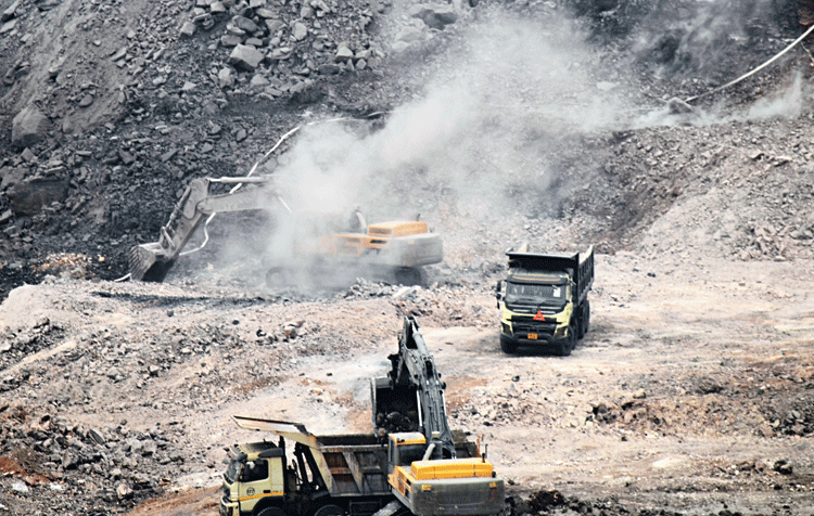 Coal dust flies in the open-cast mine of Bharat Coking Coal Limited at Rajapur in Jharia on Wednesday.
