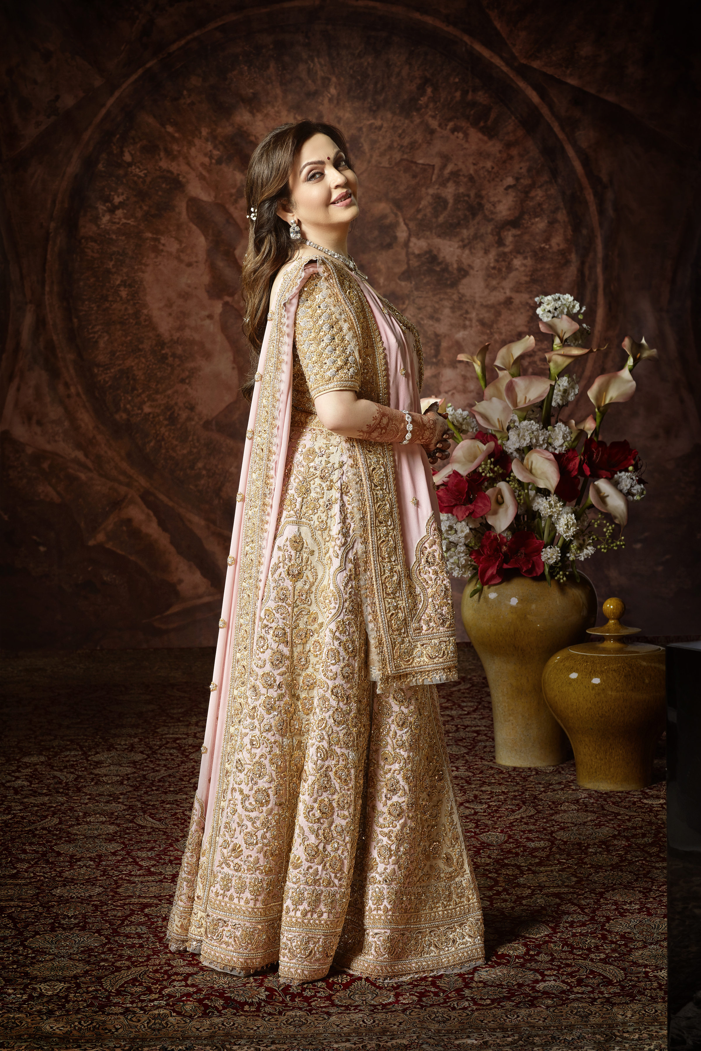 For the reception, Nita Ambani wore a two-coloured ghagra in light beige and light pink, embellished in vasli, mukaish and zardosi work. A pink dupatta with a hand-embroidered pallav with borders and booties was paired with a zardosi mukaish blouse