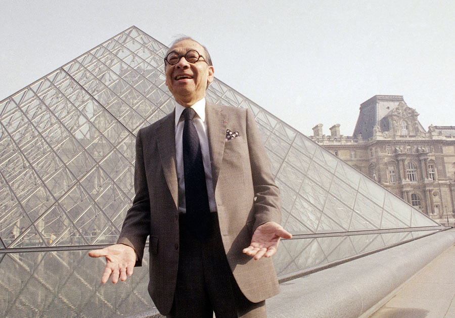 Architect I.M. Pei laughs while posing for a portrait in front of the Louvre glass pyramid, which he designed