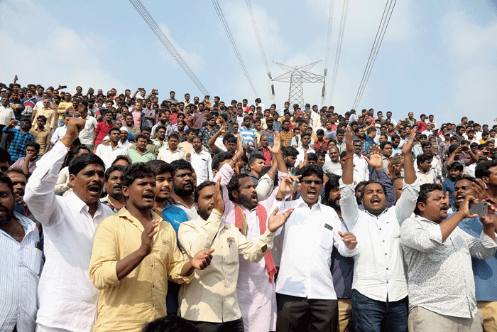 A crowd cheers police at the site where the four rape suspects were shot in Shadnagar near Hyderabad on Friday.
