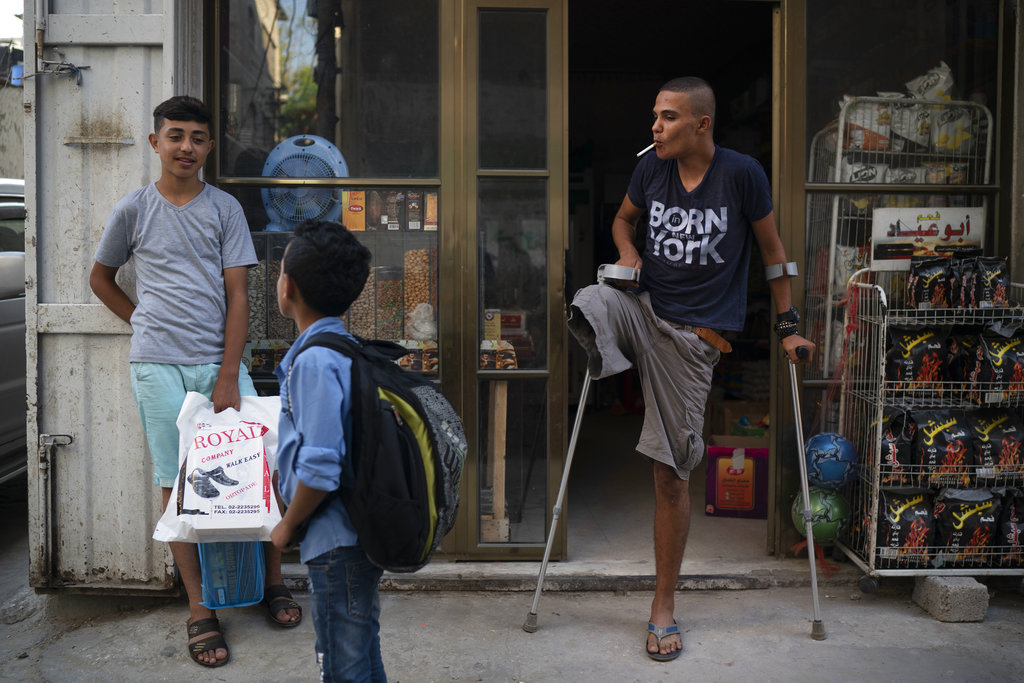 Atalla Fayoumi (right) lost his right leg after Israeli soldiers shot him in April at a mass demonstration. Yet, like other desperate young men in Gaza who feel they have nothing left to lose, the 18-year-old Palestinian has kept returning to the protests.