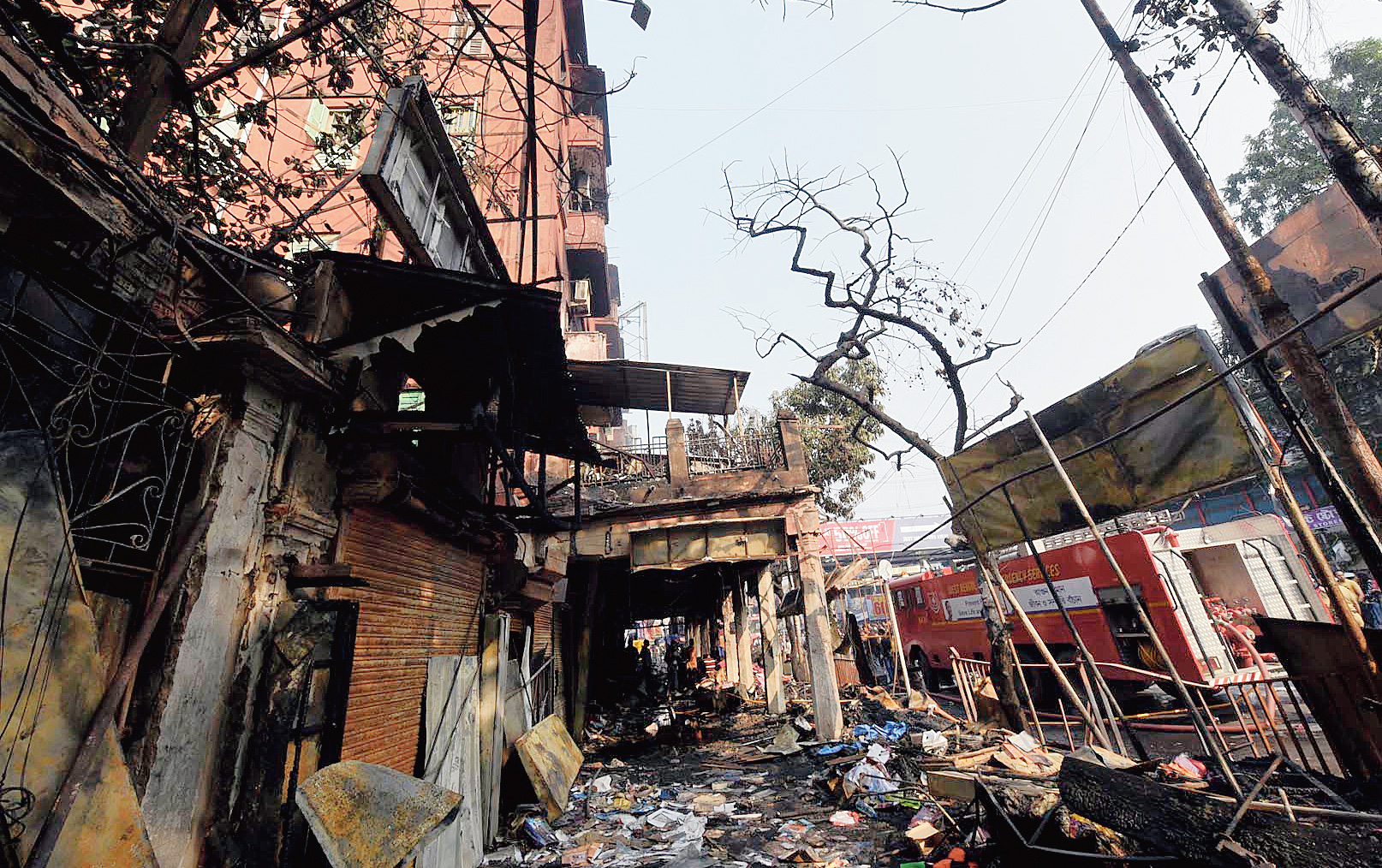 Remains of stalls that caught fire on the pavement in front of the Gariahat building that houses Traders Assembly and Adi Dhakeswari Bastralaya.