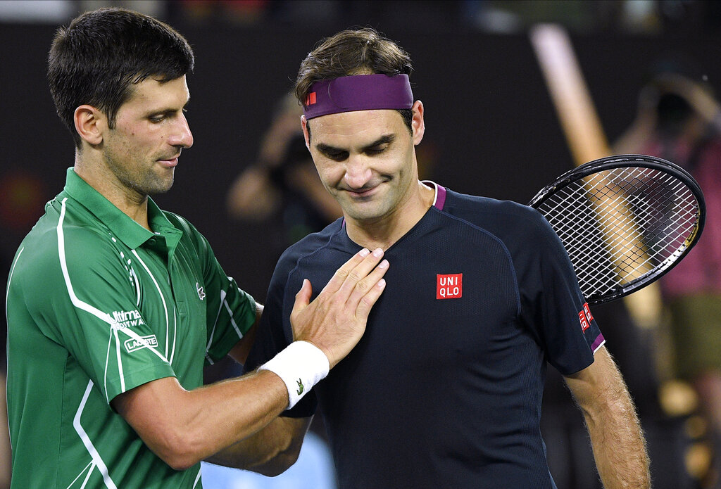 Switzerland's Roger Federer, right, congratulates Serbia's Novak Djokovic on winning their semifinal match at the Australian Open tennis championship in Melbourne, Australia, on Thursday