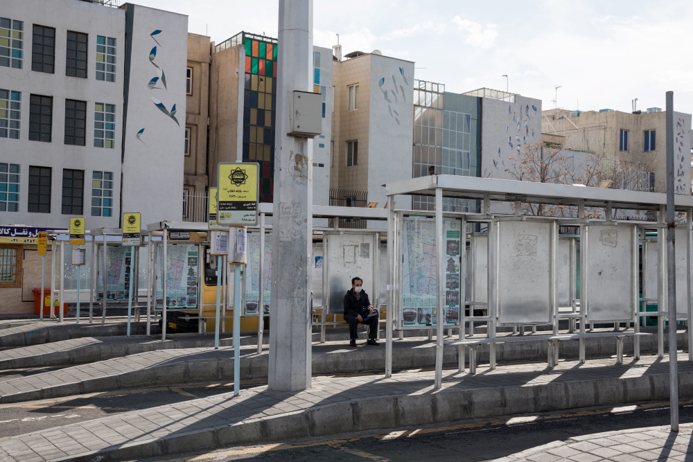 A man is sitting in an empty bus statin the eve before Persian New Year during the outbreak of coronavirus in Tehran, Iran, March 19, 2020