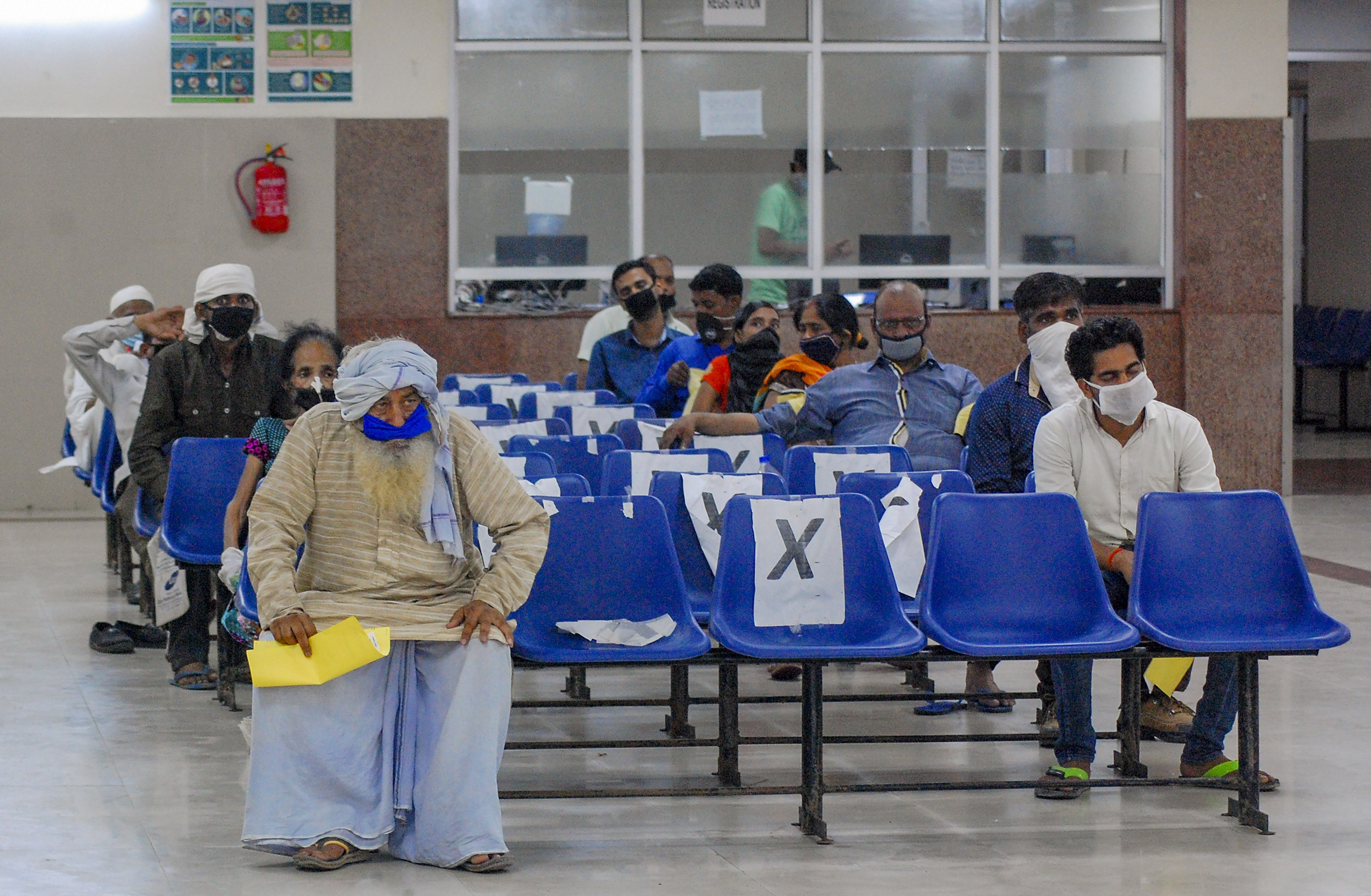 Patients showing Covid-19 symptoms wait to give samples for tests, in the isolation ward of Hallet Hospital in Kanpur, Friday, June 19, 2020.
