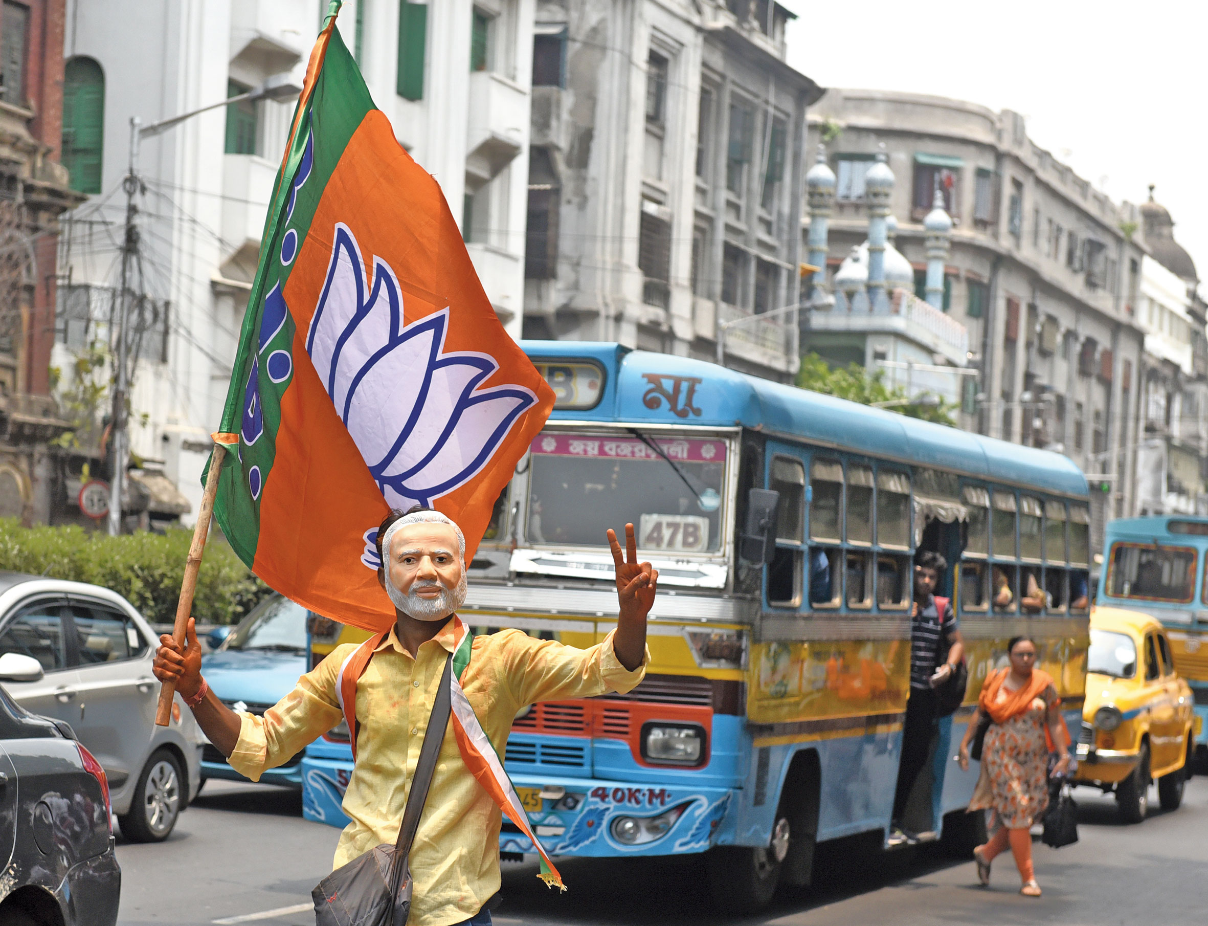 A BJP supporter wearing Narendra Modi masks celebrates in Calcutta on Thursday. 