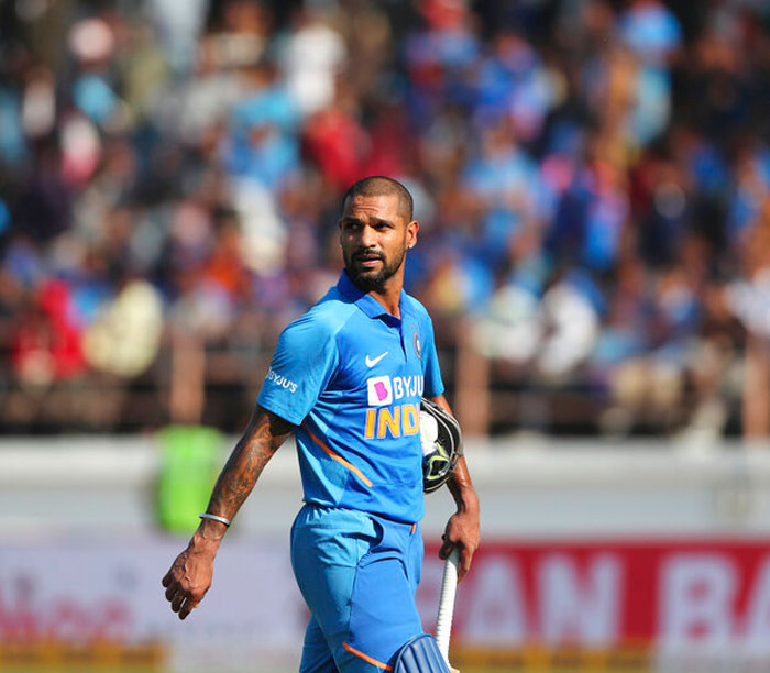India's Shikhar Dhawan looks at the screen as he leaves the field after his dismissal during the second one-day international cricket match between India and Australia in Rajkot on Friday
