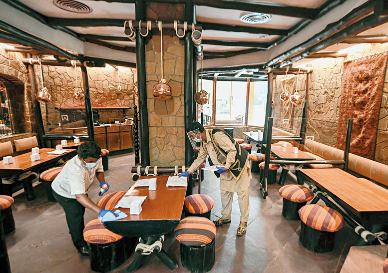 Sanitation work underway at ITC Maurya in New Delhi on Friday.