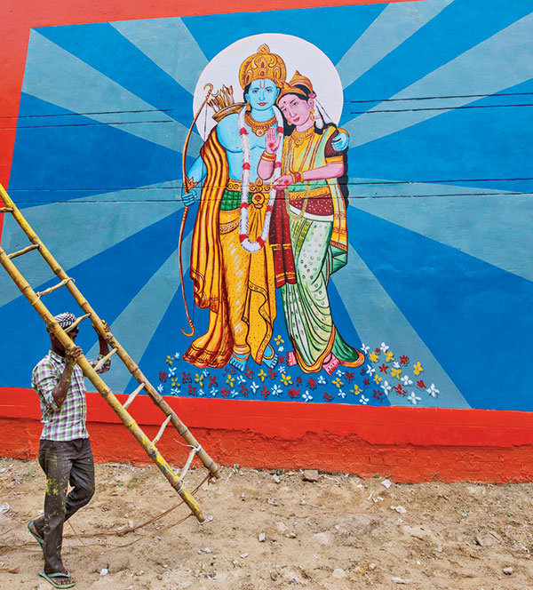 A worker on Sunday paints a street wall in Ayodhya as part of preparations for the August 5 ceremony at Ram temple.