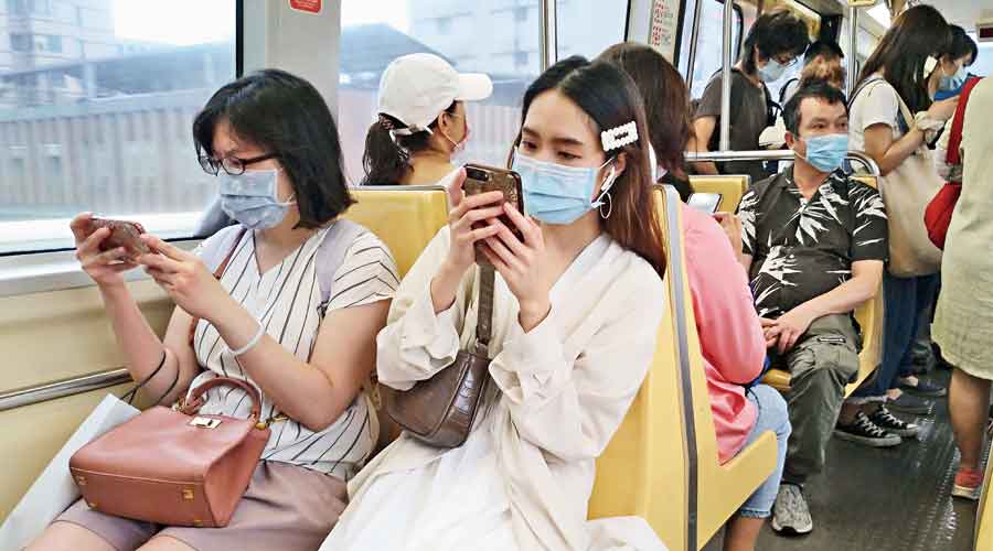 Commuters wearing masks ride the subway in Taipei, Taiwan, on Thursday