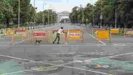 Traffic police personnel block a road during an intensified lockdown imposed as a preventive measure against the spread of coronavirus disease, in Chennai, Sunday, Aug 2, 2020.