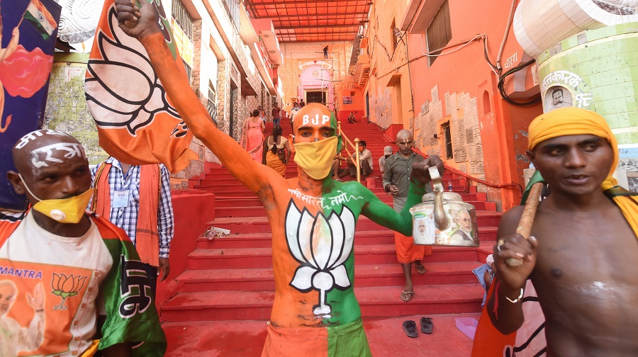 BJP workers hold their party flag outside the Hanumangarhi temple in Ayodhya on Tuesday