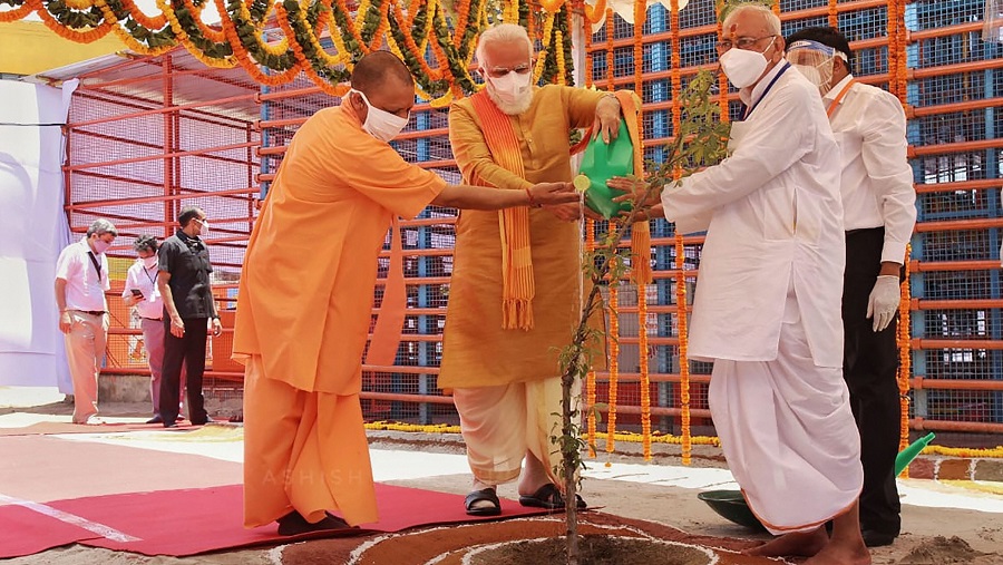 Prime Minister Narendra Modi along with UP Chief Minister Yogi Adityanath waters Parijaat sapling ahead of the inception of Bhoomi Pujan for the construction of Ram Temple in Ayodhya on Wednesday