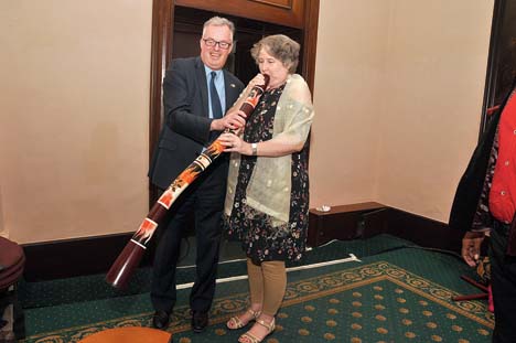 Christine Ford blows into a didgeridoo as Andrew helps her hold it. The Fords were excited to spot the wind instrument identified with the aboriginal people of northen Australia played at a party in Calcutta last January