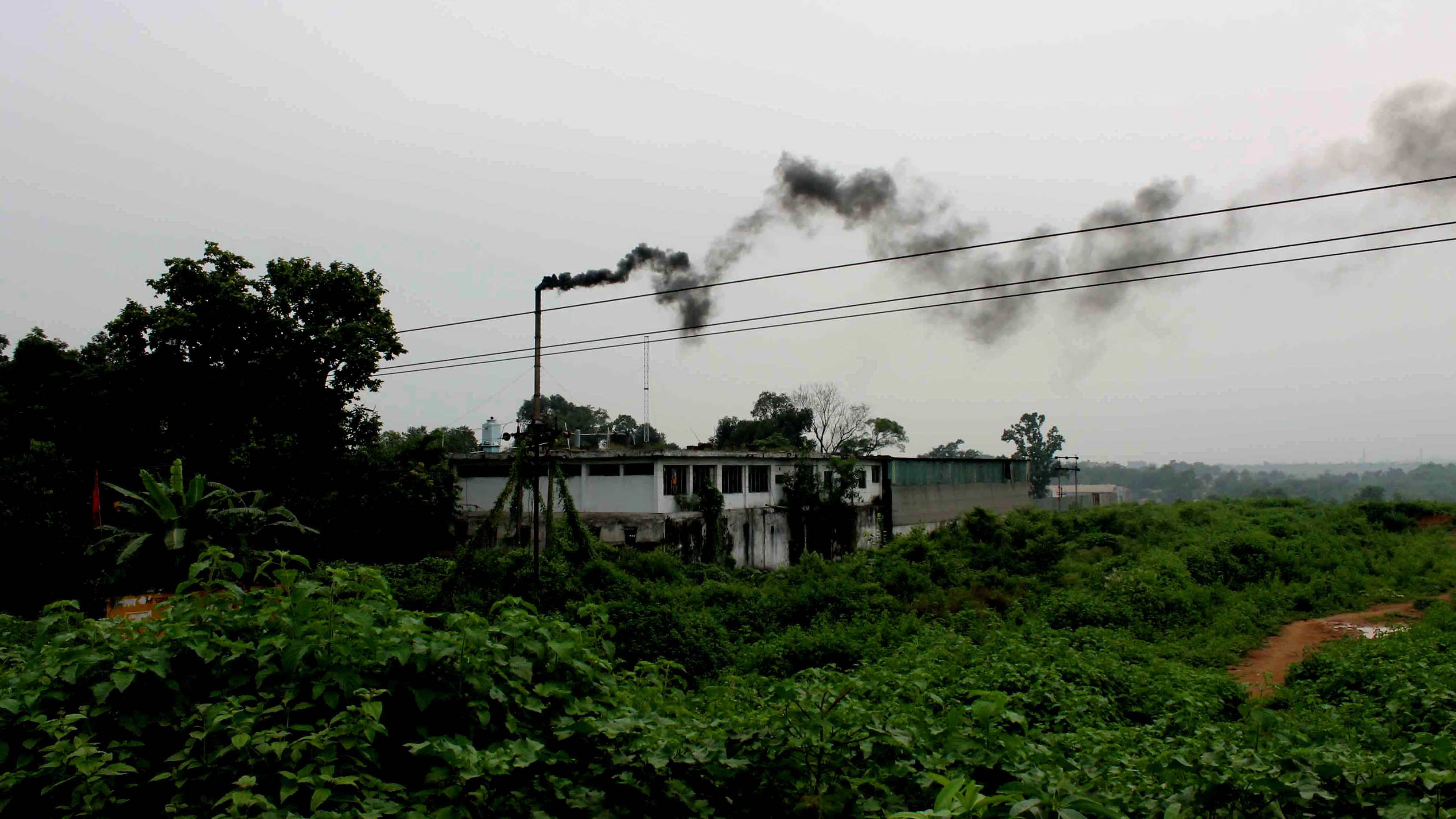 Black smoke billows into the air from an industrial unit at Adityapur.